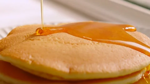 Maple Syrup Gently Pouring on Soft Buttermilk Pancakes with Golden Gooey Gloss Stock Footage 338403400