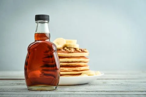 Maple syrup in glass bottle Stock Photos