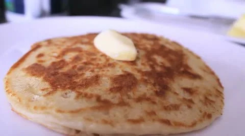 Maple syrup is poured over delicious pancake Stock Footage 12113235