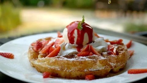 Maple Syrup pouring over delicious waffle with berries. 스톡 동영상 336589405