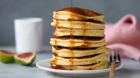 Maple syrup pouring on stack of pancakes Stock Footage 115970195