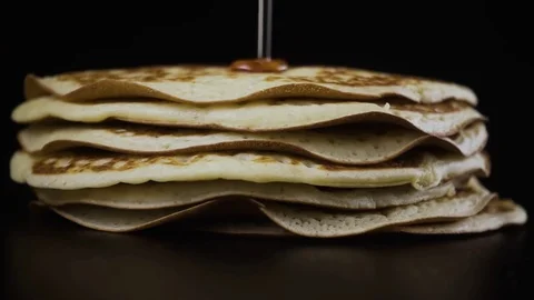 Maple syrup pours out pancakes. Slow motion Stock Footage 75034536