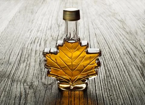 Maple syrup on wooden background Stock Photos