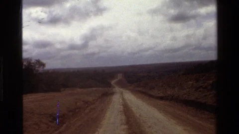 MARA TANZANIA-1983: Driving On A Bumpy Dirt Road In The Wilderness Toward A Town Video stock 122998415