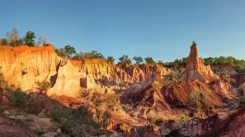Marafa Depression (Hell's Kitchen canyon) with red cliffs and rocks in aftero Stock Photos
