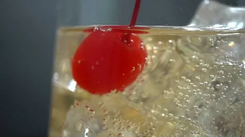 Maraschino cherry on ice in ginger ale Stock Footage 221958300