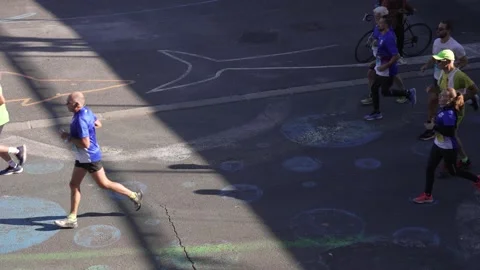 Marathon runner running on the road in the summer sun 4K Stock Footage 220952666