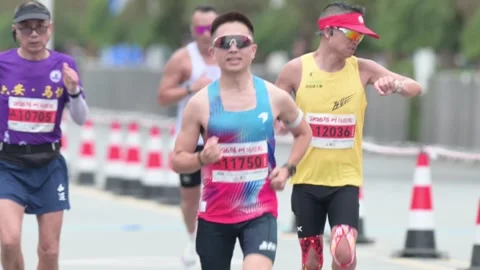Marathon Runners in Colorful Gradient Singlets Approaching Stock Footage 348071582
