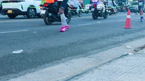 Marathon runner's legs moving along city street during long distance race, Stock Footage 335705892