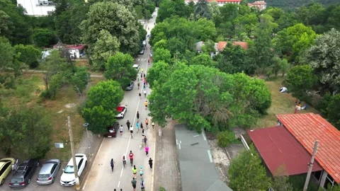 Marathon running through town 1 from drone Stock Footage 317240702
