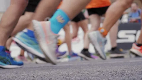 Marathon start, running people, crowd of people start run, close up of legs with Stock Footage 252761184