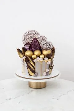 Marble anniversary gold and grey cake decorated with chocolate balls and meri Stock Photos