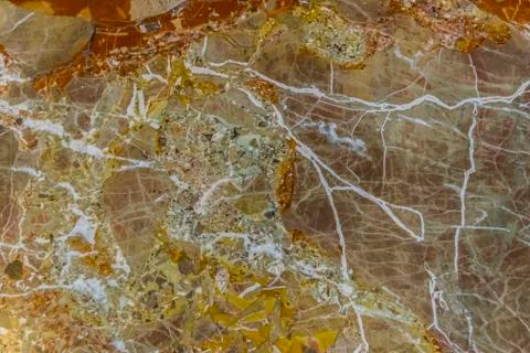 Marble background, yellow, red, white veins. Stock Photos