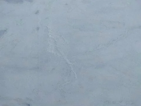 Marble background.White stone texture with gray shadow.Panoramic format. Stock Photos