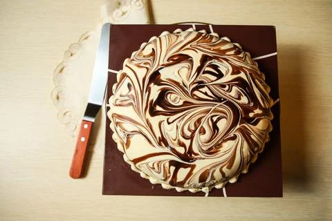 Marble Cake include chocolate, cream, sugar with knife served on board top .. Stock Photos