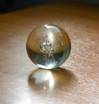 Marble (clear) on the table with shadow Stock Photos