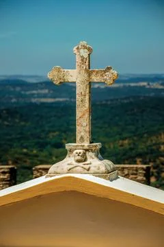 Marble cross on top of graveyard gate Stock Photos