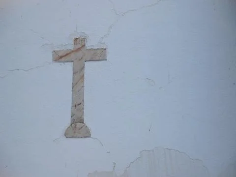 Marble cross on white wall background Stock Photos