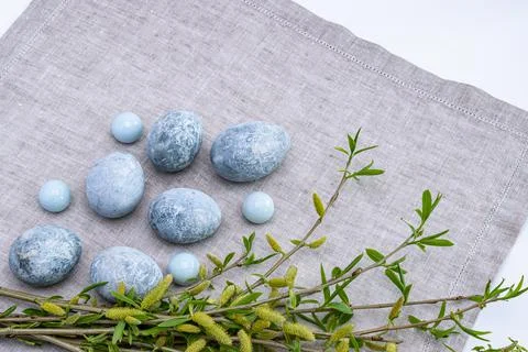 Marble Easter eggs and willow twigs on a gray linen napkin. Easter greeting c Stock Photos