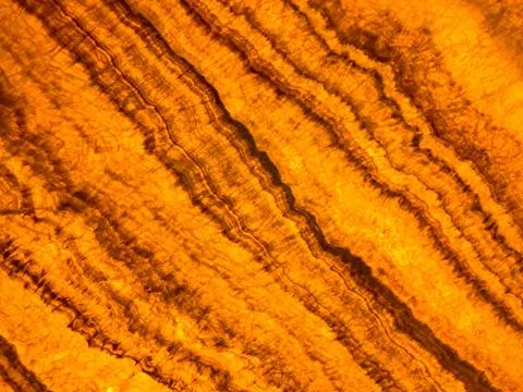 Marble effect pattern in glowing amber color Stock Photos