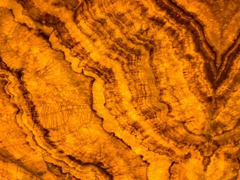 Marble effect pattern in glowing amber color Stock Photos