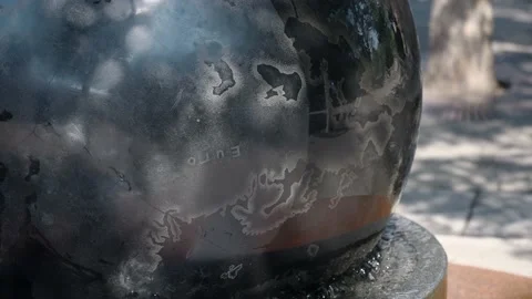 Marble globe spinning on water Stock Footage 228318397