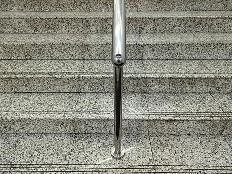 Marble patterned cement stairs with stainless steel handrails Stock Photos