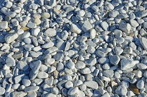 Marble pebbles of different sizes on the beach Stock Photos