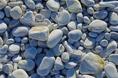 Marble pebbles of different sizes on the beach Stock Photos