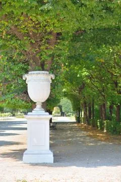 Marble pot and tree lined footpath Stock Photos