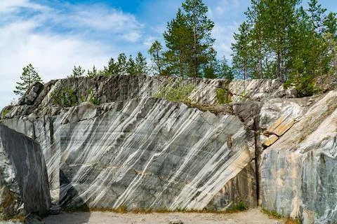 Marble Quarry with Pine Trees and Blue Sky Stock Photos