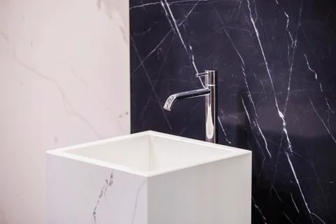 Marble sink on the background of a marble wall, black white bathroom complete Stock Photos