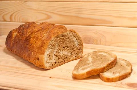 Marble sliced ??wheat - rye bread on a wooden board Stock Photos