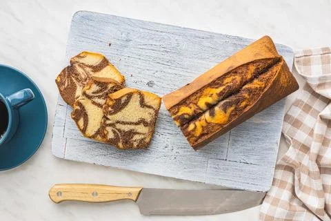 Marble sponge cake. Cake with cocoa and vanilla taste on cutting board. Stock Photos