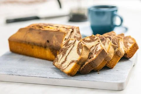 Marble sponge cake. Cake with cocoa and vanilla taste on cutting board. Stock Photos
