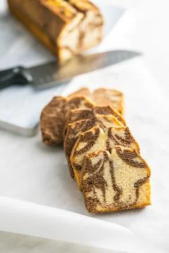 Marble sponge cake. Cake with cocoa and vanilla taste on kitchen table. Stock Photos