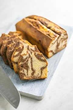 Marble sponge cake. Cake with cocoa and vanilla taste on cutting board. Stock Photos