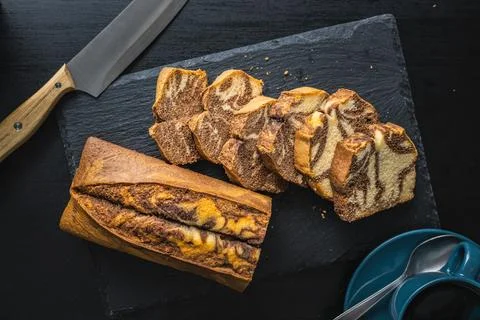 Marble sponge cake. Cake with cocoa and vanilla taste on cutting board. Stock Photos