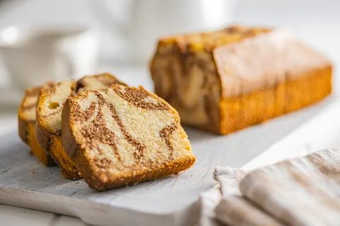Marble sponge cake. Cake with cocoa and vanilla taste on cutting board. Stock Photos