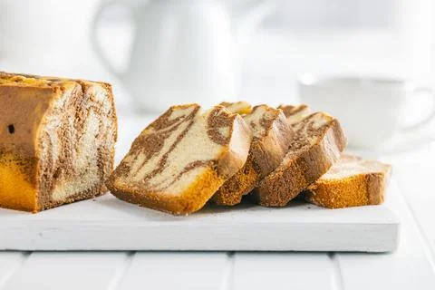 Marble sponge cake. Cake with cocoa and vanilla taste on cutting board. Stock Photos