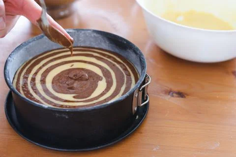 Marble sponge cake elaboration process. Copy space. Pastry. Stock Photos