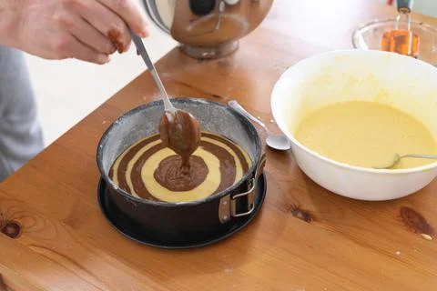 Marble sponge cake elaboration process. Copy space. Pastry. Stock Photos