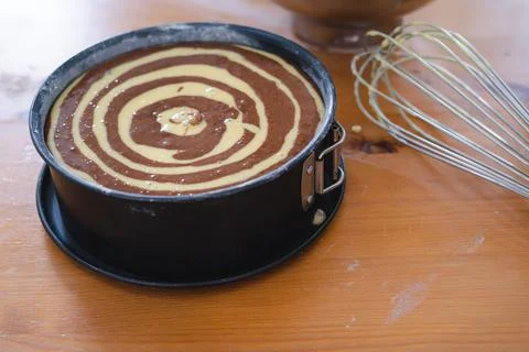 Marble sponge cake elaboration process. Copy space. Pastry. Stock Photos