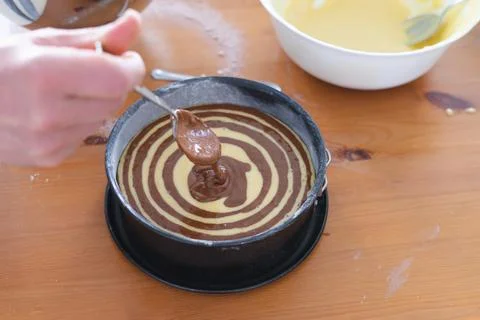 Marble sponge cake elaboration process. Copy space. Pastry. Stock Photos