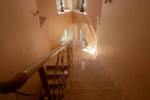 Marble staircase and Gothic windows in a modern house. Stock Photos