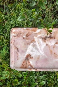 Marble stand on green grass. Empty marble capacity. Stock Photos