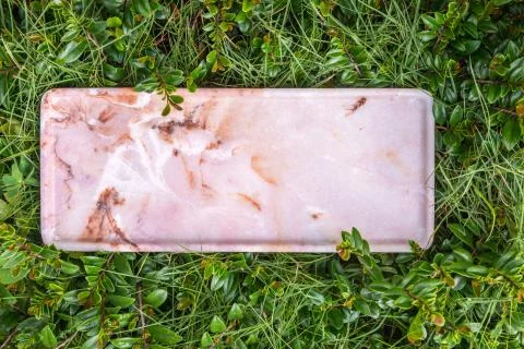 Marble stand on green grass. Empty marble capacity. Stock Photos