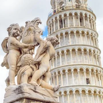 Marble statue in front of the Leaning Tower of Pisa in Piazza dei Miracoli Sq Stock Photos
