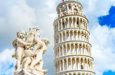Marble statue in front of the Leaning Tower of Pisa in Piazza dei Miracoli Sq Photos