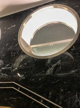 Marble surface with steel inserts in which light is reflected, round windows Stock Photos